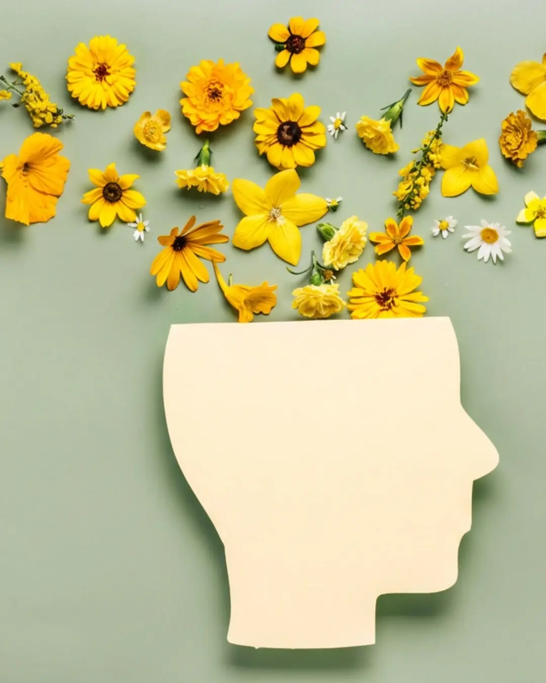 Yellow flowers arranged around a blank note